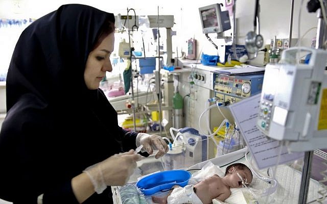 A nurse cares for a newborn baby in the Neonatal ICU of the Mofid Children Hospital in Tehran, Iran, on December 30, 2013. (photo credit: AP/Ebrahim Noroozi) A nurse cares for a newborn baby in the Neonatal ICU of the Mofid Children Hospital in Tehran, Iran, on December 30, 2013. (photo credit: AP/Ebrahim Noroozi)