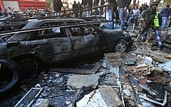 A Lebanese army soldier walks through the site of a car bombing in the southern suburb of Beirut, Lebanon, Tuesday, Jan. 21, 2014. (Photo credit: AP/Hussein Malla)