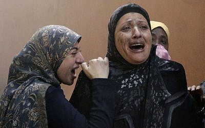 Lebanese women who left their destroyed home cry out after a car bomb explosion hit a stronghold of the Shiite Hezbollah group in a southern suburb of Beirut, Lebanon, on Thursday. (photo credit: AP/Hussein Malla)