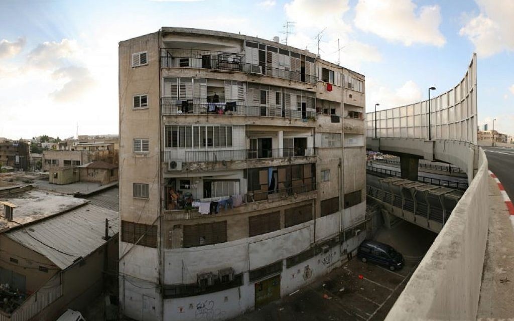 Boarding platforms at Tel Aviv's Central Bus Station run past a dilapidated apartment building in the Neve Sha'anan neighborhood. (photo credit: Wikimedia/Roi Boshi) Boarding platforms at Tel Aviv's Central Bus Station run past a dilapidated apartment building in the Neve Sha'anan neighborhood. (photo credit: Wikimedia/Roi Boshi)