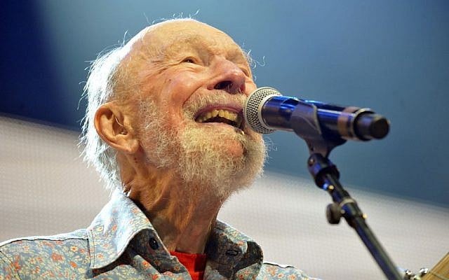This Sept. 21, 2013, file photo shows Pete Seeger performing on stage during the Farm Aid 2013 concert at Saratoga Performing Arts Center in Saratoga Springs, N.Y. The American troubadour, folk singer and activist Seeger died Monday Jan. 27, 2014, at age 94. (photo credit: AP Photo/Hans Pennink, File) This Sept. 21, 2013, file photo shows Pete Seeger performing on stage during the Farm Aid 2013 concert at Saratoga Performing Arts Center in Saratoga Springs, N.Y. The American troubadour, folk singer and activist Seeger died Monday Jan. 27, 2014, at age 94. (photo credit: AP Photo/Hans Pennink, File)