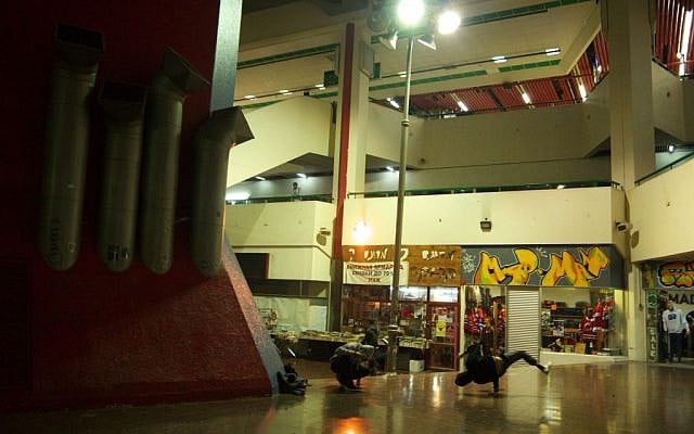 Youths practice their downrocks in Tel Aviv's Central Bus Station. (photo credit: Yifa Yaakov/The Times of Israel) Youths practice their downrocks in Tel Aviv's Central Bus Station. (photo credit: Yifa Yaakov/The Times of Israel)
