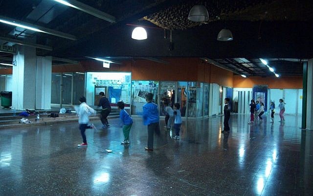 Filipino children dance to Wrecking Ball in Tel Aviv's Central Bus Station as their coach bellows instructions in crisp Hebrew. (photo credit: Yifa Yaakov/The Times of Israel) Filipino children dance to Wrecking Ball in Tel Aviv's Central Bus Station as their coach bellows instructions in crisp Hebrew. (photo credit: Yifa Yaakov/The Times of Israel)