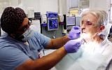 A Sikh dentist treats a patient in Quebec (YouTube screenshot)
