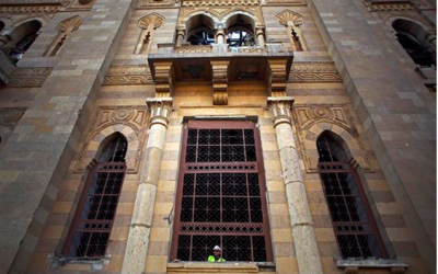 An Egyptian worker peers from the window of the damaged Museum of Islamic Art after an explosion at the Egyptian police headquarters in downtown Cairo, Friday, January 24. (photo credit: AP Photo/Khalil Hamra)