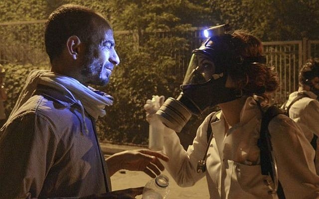A doctor helps a demonstrator affected with pepper gas during clashes with riot police near Taksim Square in Istanbul, Turkey, June 2013. (photo credit: AP/Emrah Gurel) A doctor helps a demonstrator affected with pepper gas during clashes with riot police near Taksim Square in Istanbul, Turkey, June 2013. (photo credit: AP/Emrah Gurel)