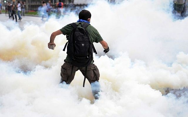 Riot police use tear gas and pressurized water to quash a demonstration by hundreds of people staging a sit-in protest to try and prevent the demolition of trees at Gezi Park in Istanbul, Turkey, May 31, 2013 . (photo credit: AP/Emrah Gurel) Riot police use tear gas and pressurized water to quash a demonstration by hundreds of people staging a sit-in protest to try and prevent the demolition of trees at Gezi Park in Istanbul, Turkey, May 31, 2013 . (photo credit: AP/Emrah Gurel)