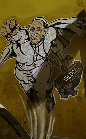 A graffiti depicting Pope Francis as Superman and holding a bag with a writing which reads: "Values" is seen on a wall of the Borgo Pio district near St. Peter's Square in Rome, Tuesday, January. 28, 2014. (photo credit: AP Photo/Gregorio Borgia)