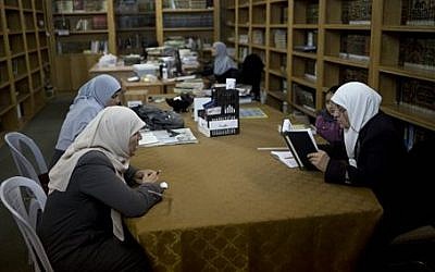Palestinian women read at the al-Aqsa mosque compound library in Jerusalem. (photo credit: AP Photo/Dusan Vranic)