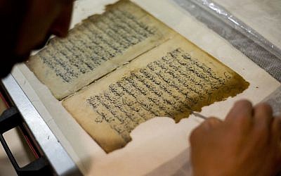 In this photo taken on Monday, Jan. 27, 2014, an employee works on a restoration of an old manuscript at the al-Aqsa mosque compound library in Jerusalem.  (photo credit: AP Photo/Dusan Vranic)