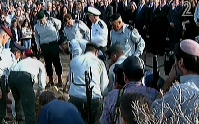 IDF major generals lay former premier Ariel Sharon in his grave in a military burial at Sharon's western Negev Sycamore Farm, January 13, 2014. (photo credit: screen shot/Channel 2)