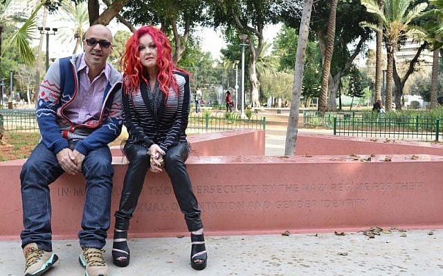 Cyndi Lauper, left, with Israeli journalist, writer and gay rights activist Gal Uchovsky sit on the memorial to gay and lesbian victims of WWII in Tel Aviv, last week (photo credit: courtesy) Cyndi Lauper, left, with Israeli journalist, writer and gay rights activist Gal Uchovsky sit on the memorial to gay and lesbian victims of WWII in Tel Aviv, last week (photo credit: courtesy)