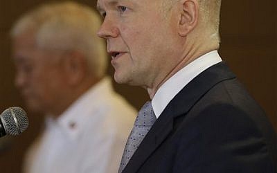 British Foreign Secretary William Hague answers questions from the media during a joint news conference with his Philippine counterpart Albert del Rosario, left, Thursday, Jan. 30, 2014 in Manila, Philippines. (photo credit: AP Photo/Bullit Marquez)
