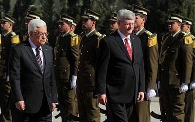 Canadian Prime Minister Stephen Harper and Palestinian Authority President Mahmoud Abbas walking past Palestinian guards,  January 20, 2014 (photo credit: Issam Rimawi/Flash90)