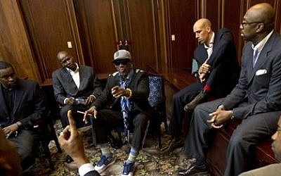 Dennis Rodman, center, speaks with fellow US basketball players during a team meeting at a Pyongyang, North Korea hotel, on Tuesday (photo credit: AP/David Guttenfelder)