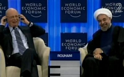 Iranian president Hassan Rouhani laughs after he is asked at the Davos forum if he would reach out with all countries in the region (screen capture: Channel 2)