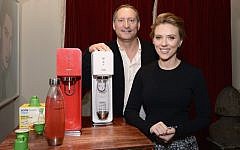 Scarlett Johansson with Sodastream's Daniel Birnbaum (photo credit: Mike Coppola/Getty Images for SodaStream/via JTA)