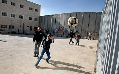 Palestinian schoolchildren playing soccer around the security barrier in the West Bank (illustrative photo: Flash 90) Palestinian schoolchildren playing soccer around the security barrier in the West Bank (illustrative photo: Flash 90)