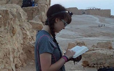 Avigayil Halpern prays for the first time with tefillin at Masada, summer 2013. (photo credit: Courtesy)
