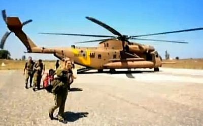 Israeli soldiers disembark from a helicopter en route to a secret military hospital on the border with Syria. (photo credit: screen capture, Channel 2)
