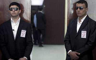 Private guards from Gaza's first private security company 'Secure Land' stand in front of a door during a visit of Palestinian singer and Arab Idol winner Mohammed Assaf at Palestine University in Gaza City, on February 10, 2014. (photo credit: AFP/Mahmud Hams)