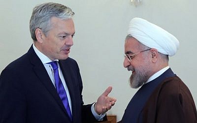 Iranian President Hassan Rouhani (R) welcomes Belgian Foreign Minister Didier Reynders in Tehran on February 23, 2014. (photo credit: AFP photo/Atta Kenare)