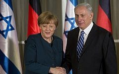 German Chancellor Angela Merkel (left) shakes hands with Prime Minister Benjamin Netanyahu after arriving in Jerusalem on February 24, 2014. (Sebastian Scheiner/AFP)
