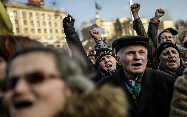 Anti-government protesters shout slogans at Independence Square, in Kiev, Ukraine, on Friday (photo credit: Bulent Kilic/AFP)