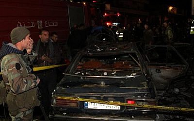 Lebanese emergency personnel at the site of a car bomb explosion targeting a petrol station in Hermel, Lebanon, Saturday, February 1, 2014 (photo credit: AFP)