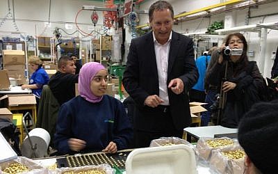 Sodastream CEO Daniel Birnbaum stands next to Palestinian and Jewish employees, February 2, 2014 [photo credit: Elhanan Miller/TOI]