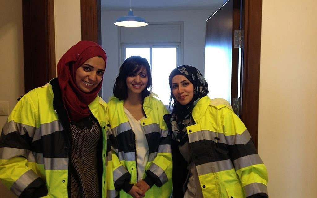 Civil engineer Shadia Jaradat (center) poses with two colleagues in one of Rawabi's model apartments. A third of the project's engineers are women (photo credit: Elhanan Miller/Times of Israel)