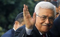 Palestinian Authority President Mahmoud Abbas greets reporters as he arrives at Arab League headquarters in Cairo, Egypt, Saturday, Dec. 21, 2013 (photo credit: AP/Amr Nabil)