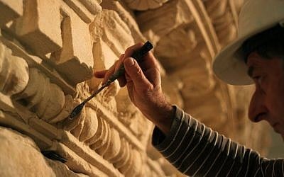 A restorer at the Israel Museum works on a reassembled display of what curators say was Herod's tomb in the Israeli museum, Jerusalem, Tuesday, Jan. 15, 2012 (photo credit: AP/Daniel Estrin)