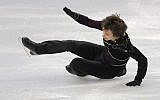 Alexei Bychenko falls on his quad attempt during the men's free skate at the 2014 Olympic Winter Games in Sochi, Russia, on Friday (photo credit: AP/Vadim Ghirda)