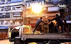 Rebels fire their anti-aircraft gun at Syrian army airplanes in Aleppo, Syria, Saturday Feb. 1, 2014.  (photo credit: AP/Aleppo Media Center, AMC)