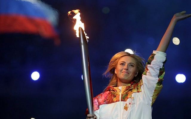 Russia's Maria Sharapova carries the torch during the opening ceremony of the 2014 Winter Olympics in Sochi, Russia, Friday, Feb. 7, 2014. (photo credit: AP/Matt Dunham) Russia's Maria Sharapova carries the torch during the opening ceremony of the 2014 Winter Olympics in Sochi, Russia, Friday, Feb. 7, 2014. (photo credit: AP/Matt Dunham)