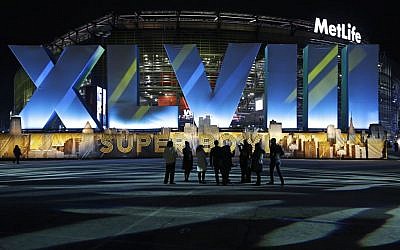 Fans walk near MetLife Stadium before the NFL Super Bowl XLVIII football game between the Seattle Seahawks and the Denver Broncos Sunday, Feb. 2, 2014. (photo credit: AP/Seth Wenig)
