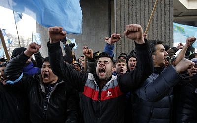 Crimean Tatars shout slogans during a protest in front of a local government building in Simferopol, Crimea, Ukraine, Wednesday, Feb. 26, 2014. (photo credit: AP Photo/Darko Vojinovic)