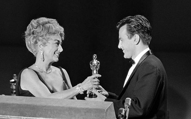 In this April 9, 1962 file picture Joan Crawford, acting as presenter for the Academy of Motion Picture Arts and Sciences, presents an Oscar to Maximilian Schell on the stage at Santa Monica, Calif., April 9, 1962, after he was named as best actor of the year for his performance in “Judgment at Nuremberg.” (photo credit: AP Photo,File) In this April 9, 1962 file picture Joan Crawford, acting as presenter for the Academy of Motion Picture Arts and Sciences, presents an Oscar to Maximilian Schell on the stage at Santa Monica, Calif., April 9, 1962, after he was named as best actor of the year for his performance in “Judgment at Nuremberg.” (photo credit: AP Photo,File)