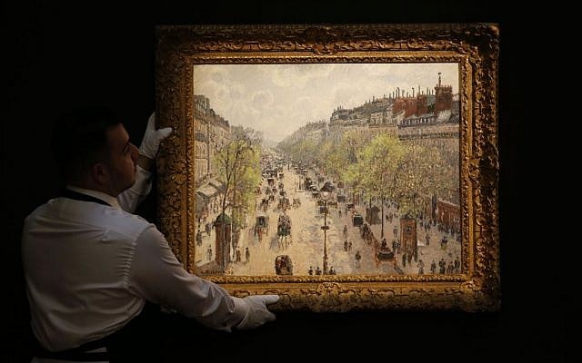 A Sotheby's employee poses with a painting entitled 'Le Boulevard Montmartre, matinee de printemps' by Camille Pissarro on display at the auction house in London, Wednesday, Jan. 29, 2014. (AP Photo/Sang Tan) A Sotheby's employee poses with a painting entitled 'Le Boulevard Montmartre, matinee de printemps' by Camille Pissarro on display at the auction house in London, Wednesday, Jan. 29, 2014. (AP Photo/Sang Tan)