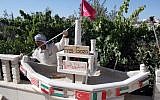 In this 2010 photo, a Palestinian in the city of Hebron builds a miniature ship to show support for the flotilla to Gaza, which became the Mavi Marmara incident.  Israel has offered new compensation to Turkey to normalize the strained relations from the incident (photo credit: NAJEH HASHLAMOUN/FLASH90)