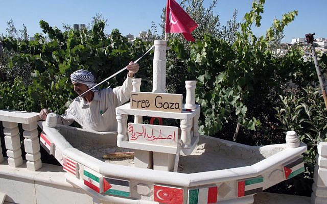 In this 2010 photo, a Palestinian in the city of Hebron builds a miniature ship to show support for the flotilla to Gaza, which became the Mavi Marmara incident. Israel has offered new compensation to Turkey to normalize the strained relations from the incident (photo credit: NAJEH HASHLAMOUN/FLASH90) In this 2010 photo, a Palestinian in the city of Hebron builds a miniature ship to show support for the flotilla to Gaza, which became the Mavi Marmara incident. Israel has offered new compensation to Turkey to normalize the strained relations from the incident (photo credit: NAJEH HASHLAMOUN/FLASH90)