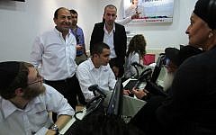 Rami Levy (standing, left) at a cellphone sales center in one of the supermarkets bearing his name. (photo credit: Yossi Zamir/Flash90)