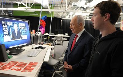 President Shimon Peres with Facebook founder Mark Zuckerberg in March 2012 (photo credit: Moshe Milner/ GPO/ Flash 90)