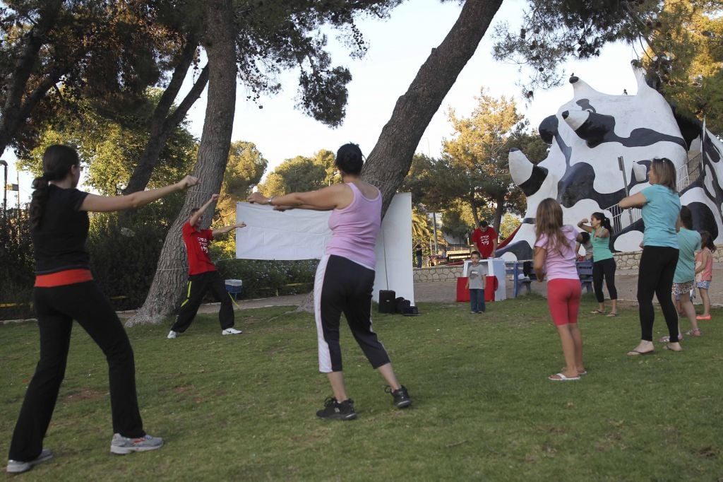 Practicing Zumba on the green, shady expanses of Kiryat Hayovel's 'Monster Park,' which is likely to be destroyed for the light rail project (photo credit: Nati Shochat/Flash 90)
