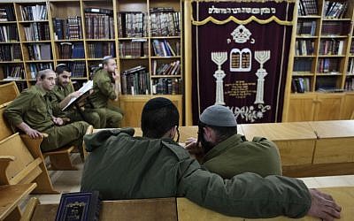 Soldiers of the IDF's ultra-Orthodox 'Netzah Yehuda' infantry unit seen studying at the Peles military base in the northern Jordan Valley. (photo credit: Yaakov Naumi/Flash90)
