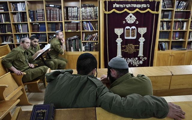 Soldiers of the IDF's ultra-Orthodox 'Netzah Yehuda' infantry unit seen studying at the Peles military base in the northern Jordan Valley. (photo credit: Yaakov Naumi/Flash90) Soldiers of the IDF's ultra-Orthodox 'Netzah Yehuda' infantry unit seen studying at the Peles military base in the northern Jordan Valley. (photo credit: Yaakov Naumi/Flash90)