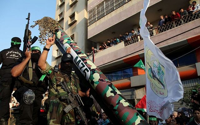 Hamas terrorists show off an M-75 home made rocket in a military parade marking the first anniversary of the eight-day Operation Pillar of Defense, in Gaza City, 14 November 2013. (photo credit: Emad Nassar/Flash90)