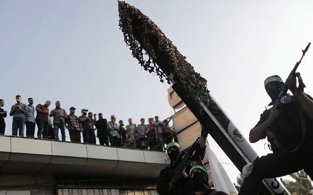 Hamas gunmen parade with an M-75 rocket on the first anniversary of Operation Pillar of Defense, in Gaza City, 14 November 2013. (Photo credit: Wissam Nassar/Flash90)