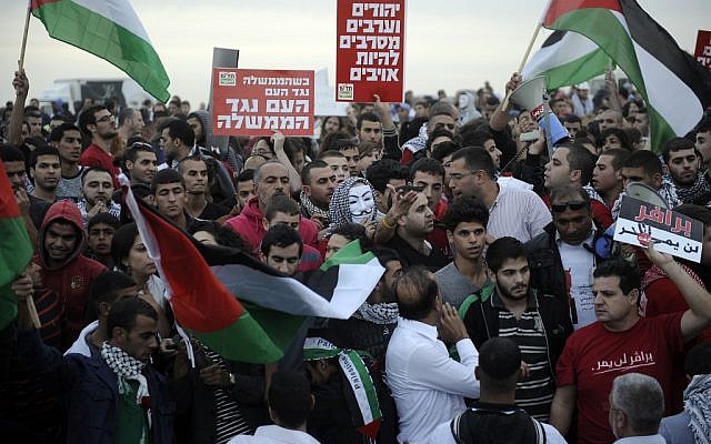 Police and protesters clash at a rally where around 1,200 demonstrators gathered in the southern Israeli town of Hura during a protest against the government's plan to resettle Bedouin residents of the Negev, November 30, 2013. (Photo credit: DAVID BUIMOVITCH/FLASH90) Police and protesters clash at a rally where around 1,200 demonstrators gathered in the southern Israeli town of Hura during a protest against the government's plan to resettle Bedouin residents of the Negev, November 30, 2013. (Photo credit: DAVID BUIMOVITCH/FLASH90)